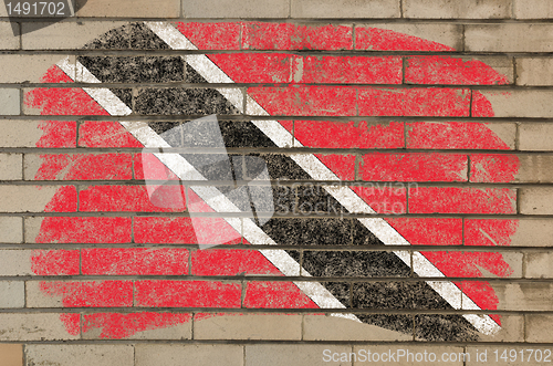 Image of flag of trinidad and tobago on grunge brick wall painted with ch
