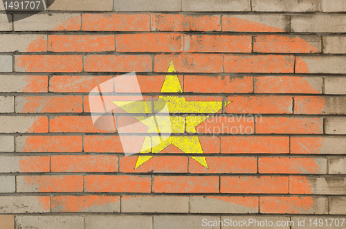 Image of flag of vietnam on grunge brick wall painted with chalk  