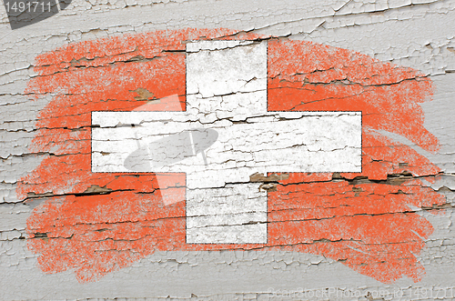 Image of flag of schwitzerland on grunge wooden texture painted with chal
