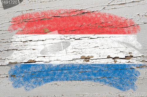 Image of flag of Netherlands on grunge wooden texture painted with chalk 