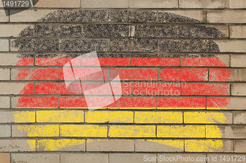 Image of flag of Germany on grunge brick wall painted with chalk  