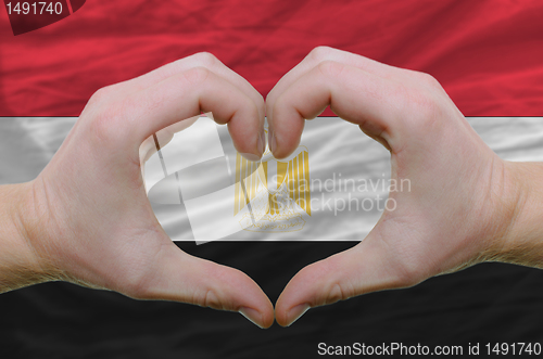 Image of Heart and love gesture showed by hands over flag of egypt backgr