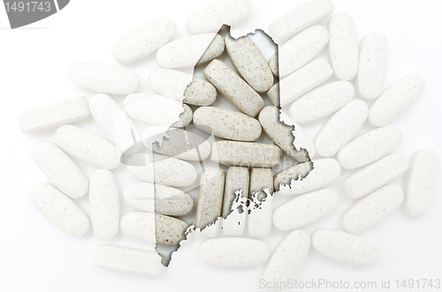 Image of Outline map of maine with transparent pills in the background
