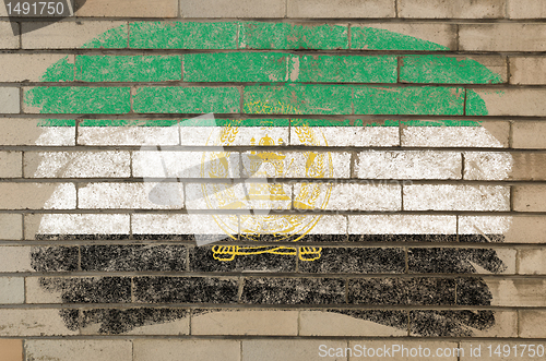 Image of flag of  afghanistan on grunge brick wall painted with chalk  