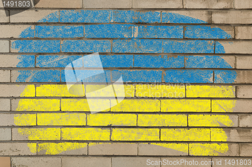 Image of flag of ukraine on grunge brick wall painted with chalk  