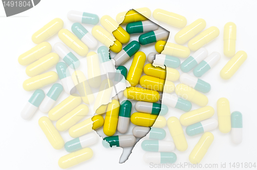 Image of Outline map of new jersey with transparent pills in the backgrou