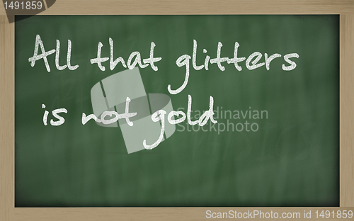 Image of " All that glitters is not gold " written on a blackboard