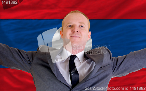 Image of happy businessman because of profitable investment in laos stand