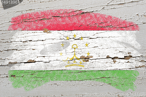 Image of flag of tajikistan on grunge wooden texture painted with chalk  