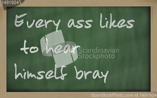 Image of " Every ass likes to hear himself bray " written on a blackboard