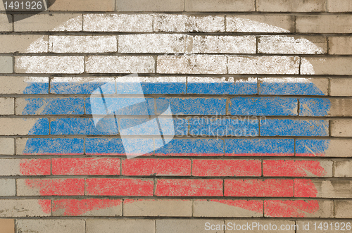 Image of flag of Russia on grunge brick wall painted with chalk  