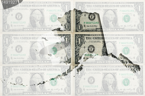 Image of Outline map of Alaska with transparent american dollar banknotes