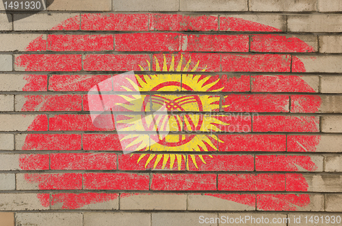 Image of flag of kyrghyzstan on grunge brick wall painted with chalk  