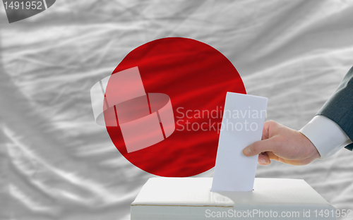 Image of man voting on elections in japan