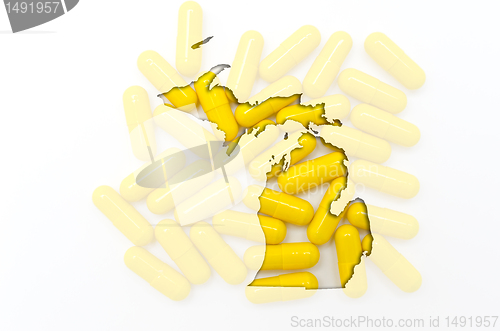 Image of Outline map of michigan with transparent pills in the background