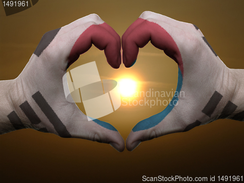 Image of Heart and love gesture by hands colored in south korea flag duri