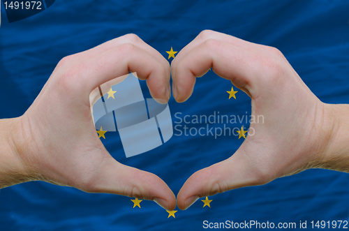 Image of Heart and love gesture showed by hands over flag of eu backgroun