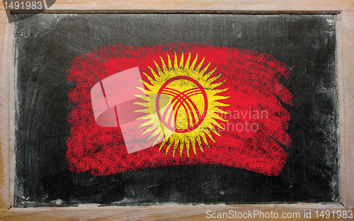 Image of flag of kyrghyzstan on blackboard painted with chalk  
