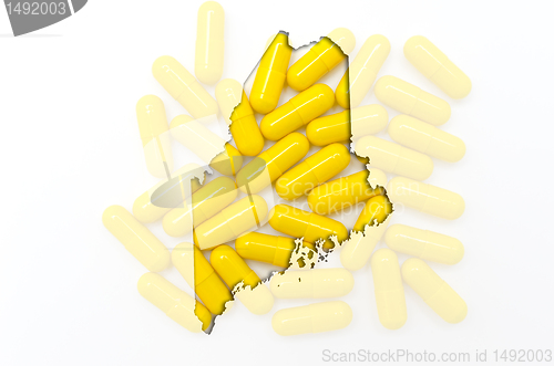 Image of Outline map of maine with transparent pills in the background