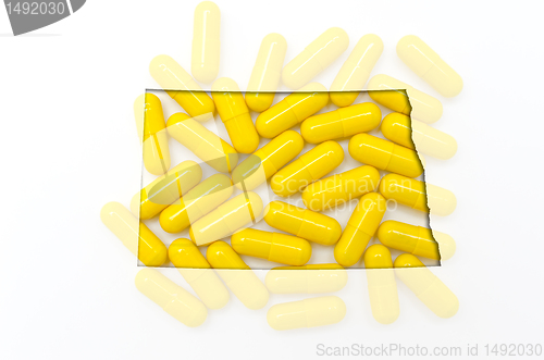 Image of Outline map of north dakota with transparent pills in the backgr