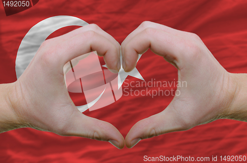 Image of Heart and love gesture showed by hands over flag of turkey backg