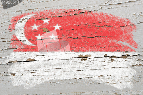 Image of flag of Singapore on grunge wooden texture painted with chalk  