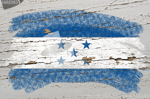 Image of flag of Honduras on grunge wooden texture painted with chalk  