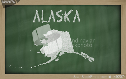 Image of outline map of alaska on blackboard 