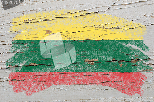 Image of flag of lithuania on grunge wooden texture painted with chalk  