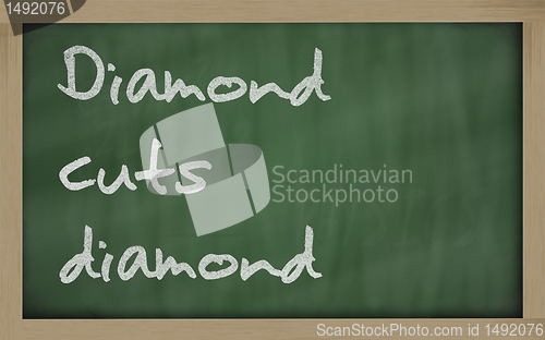 Image of " Diamond cuts diamond " written on a blackboard