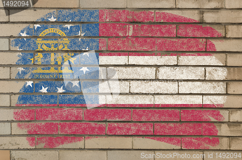 Image of flag of georgia on grunge brick wall painted with chalk  