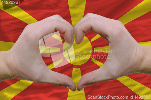 Image of Heart and love gesture showed by hands over flag of macedonia ba