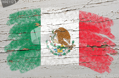 Image of flag of mexico on grunge wooden texture painted with chalk  