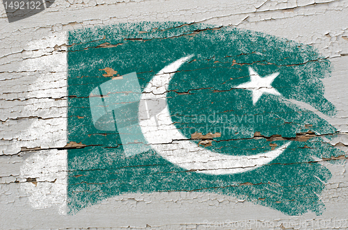 Image of flag of Pakistan on grunge wooden texture painted with chalk  