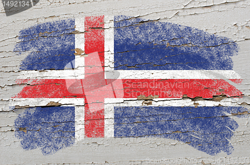 Image of flag of iceland on grunge wooden texture painted with chalk  