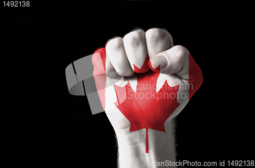 Image of Fist painted in colors of canada flag