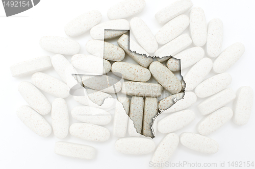 Image of Outline map of texas with transparent pills in the background