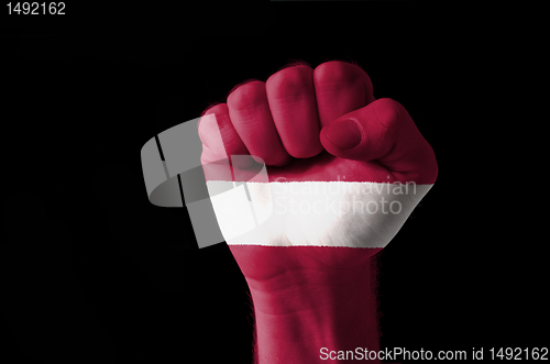 Image of Fist painted in colors of latvia flag