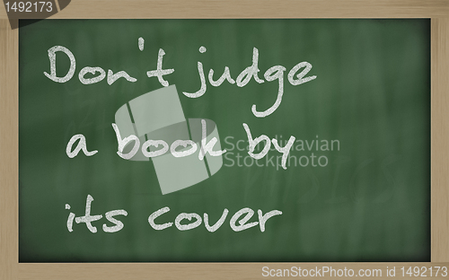 Image of " Don't judge a book by its cover " written on a blackboard
