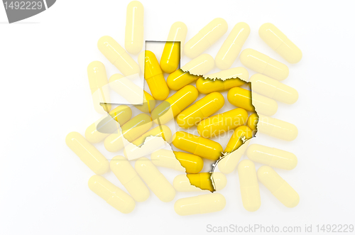Image of Outline map of texas with transparent pills in the background