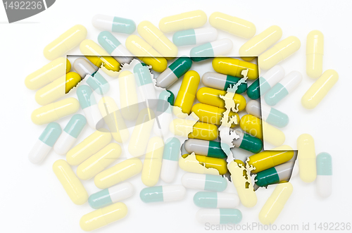 Image of Outline map of maryland with transparent pills in the background