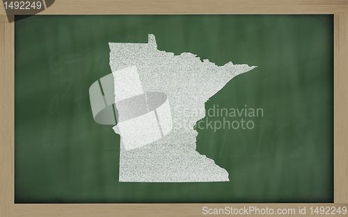 Image of outline map of minnesota on blackboard 