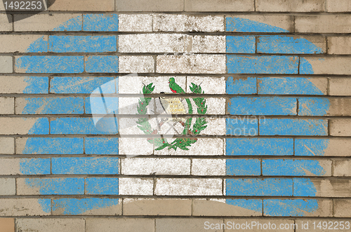 Image of flag of guatemala on grunge brick wall painted with chalk  