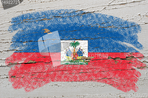 Image of flag of haiti on grunge wooden texture painted with chalk  