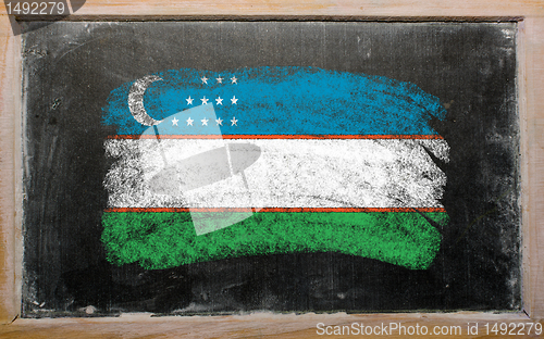 Image of flag of uzbekistan on blackboard painted with chalk  