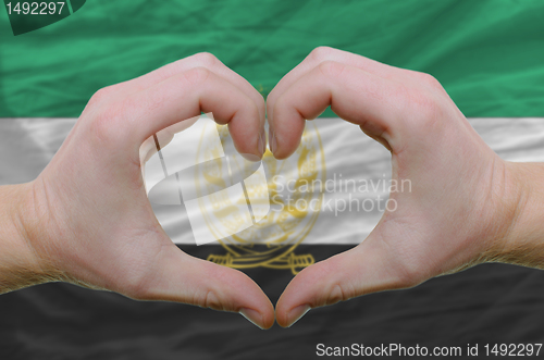 Image of Heart and love gesture showed by hands over flag of Afghanistan 