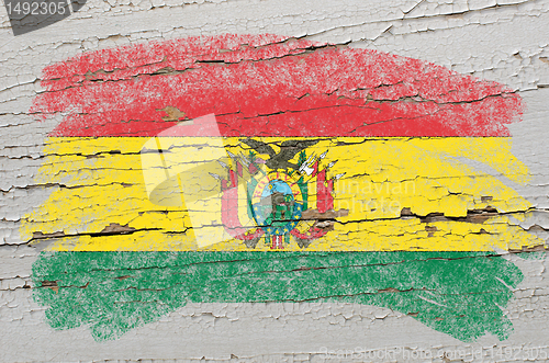 Image of flag of bolivia on grunge wooden texture painted with chalk  