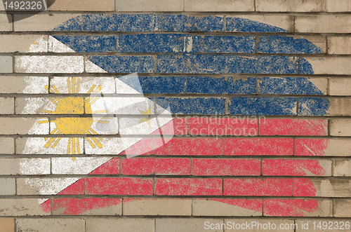 Image of flag of phillipines on grunge brick wall painted with chalk  