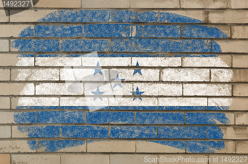 Image of flag of honduras on grunge brick wall painted with chalk  