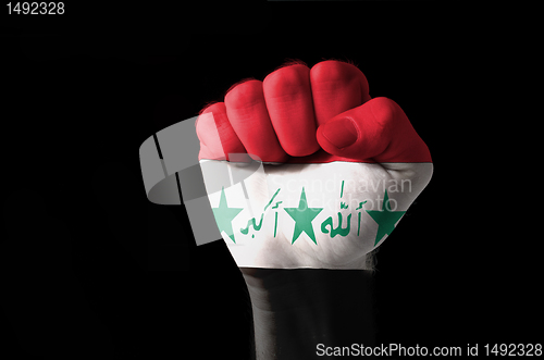 Image of Fist painted in colors of iraq flag